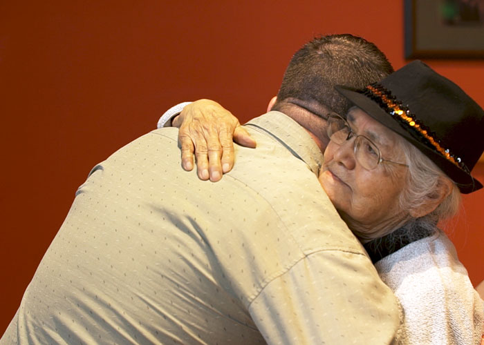 Photo of Orman Morton, '16 and Dr. Dr. Delphine Jackson, M.S. '79 hugging