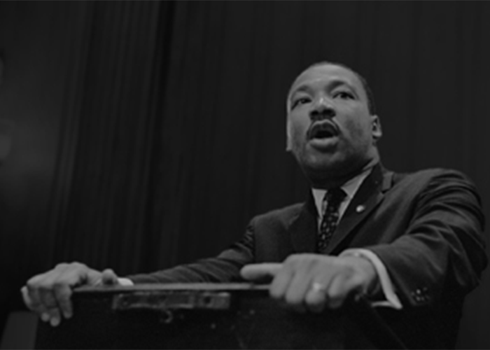 MLK speaking at a podium. 