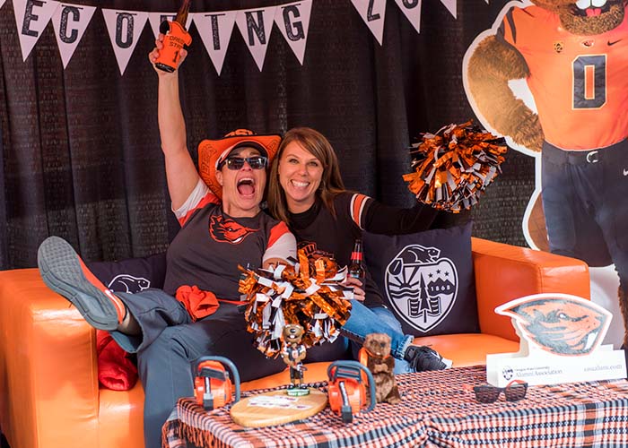 Photo of two Beaver fans posing in the Benny's Birthday Bash photo booth