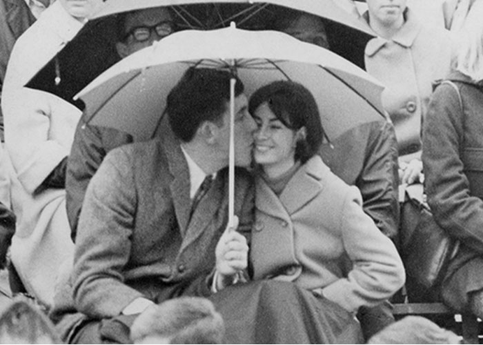 OSU couple under a umbrella