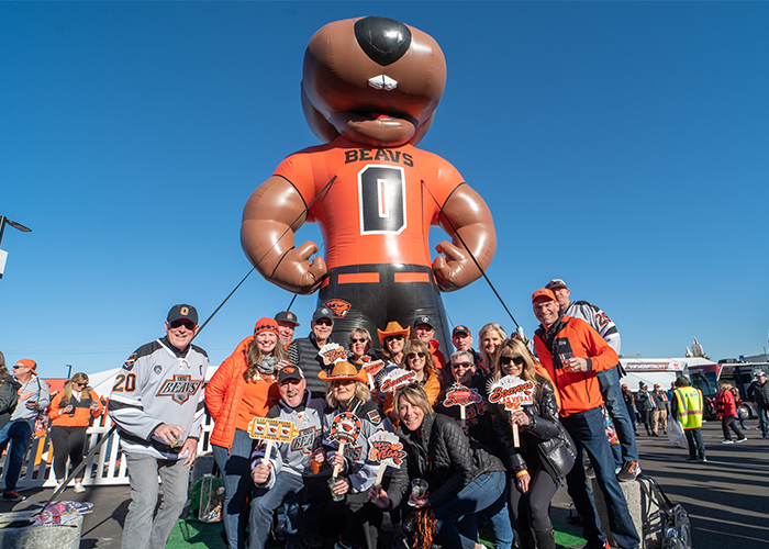 group of tailgate guests posing in front of Big Benny