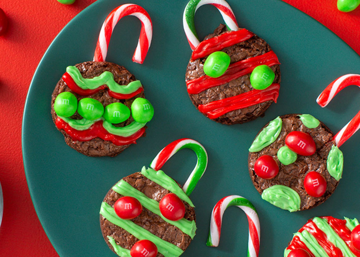 round brownie cutouts decorated as ornaments in red and green