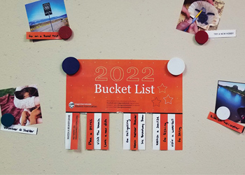 Membership printable hanging on a light colored refrigerator door with photos around it