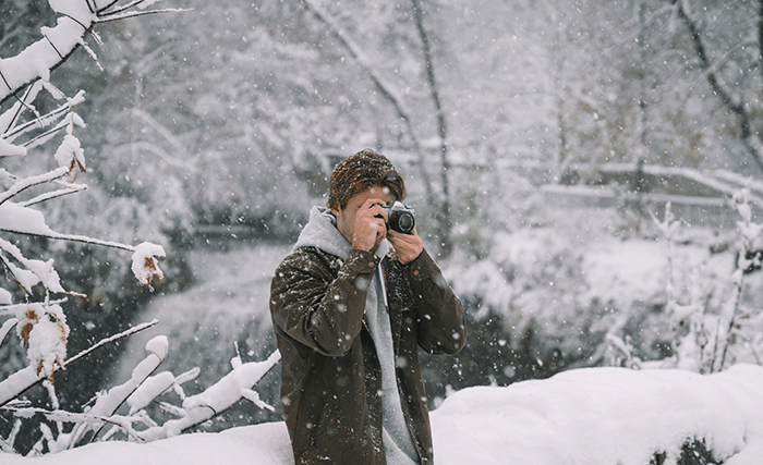 Man taking photos during winter